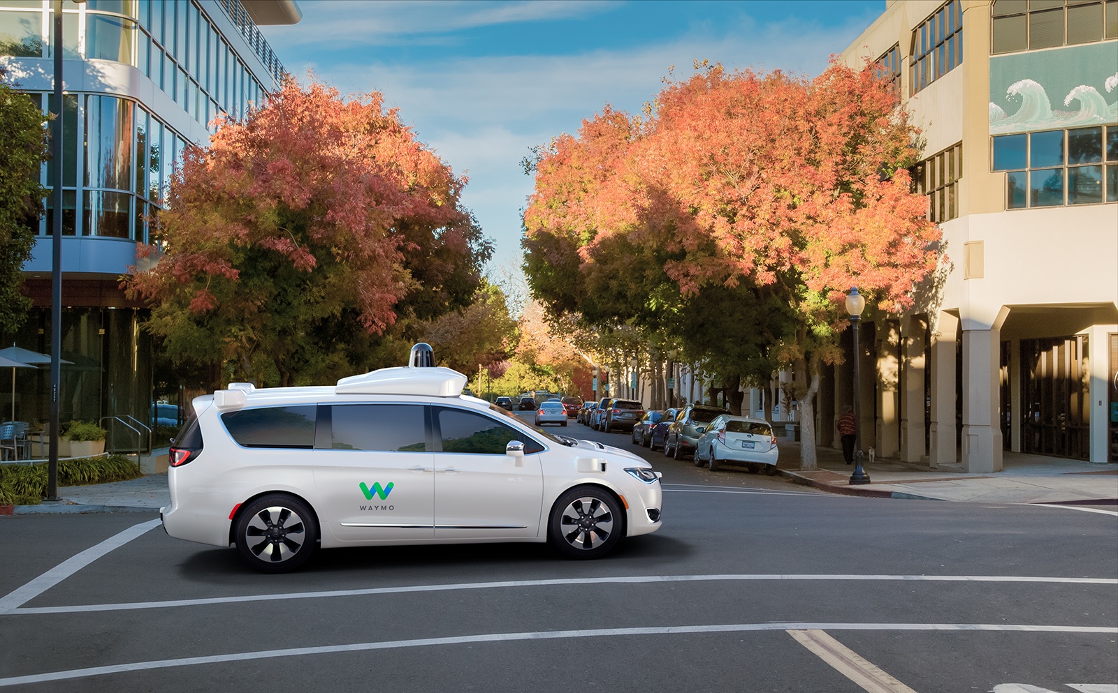 white Waymo van in a city intersection