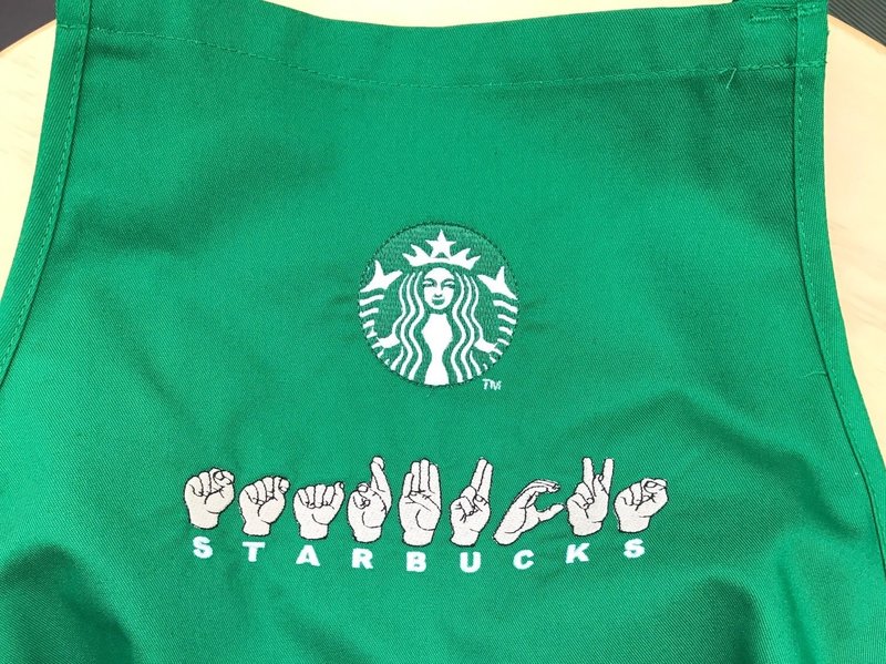 starbucks apron with sign language hands spelling out "Starbucks" embroidered on it
