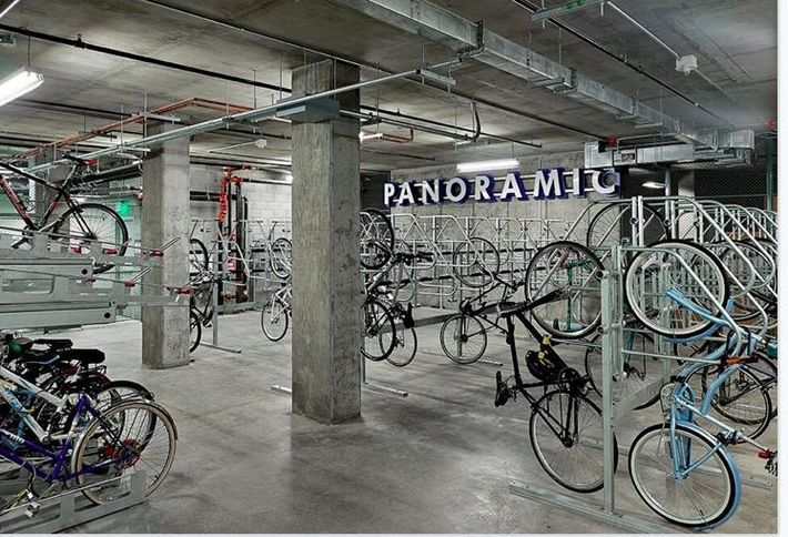 Private parking garage containing many bicycles. 