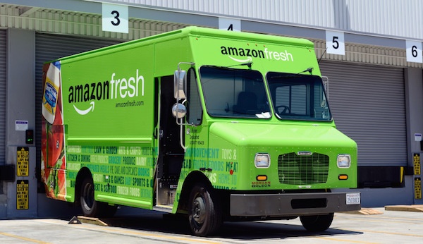 A bright green Amazon Fresh delivery truck. 