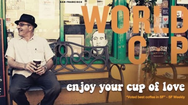 vintage looking image of a man sitting on a bench with a fedora on, holding a cup of coffee. there's a quote on the image that says "world cup. enjoy your cup of love."