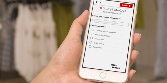 Close-up of woman holding an iPhone while using Macy's mobile tool. 