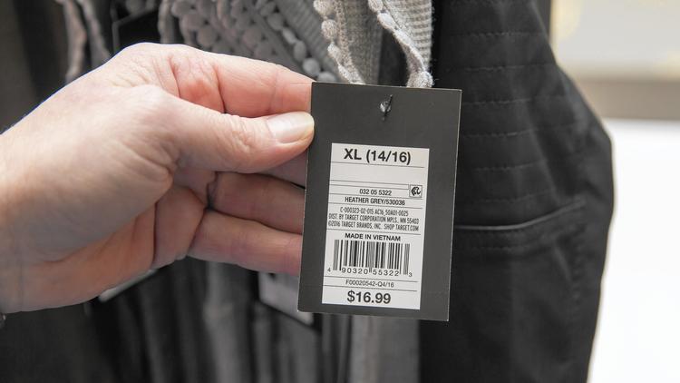 Close-up of a customer holding a price tag. 