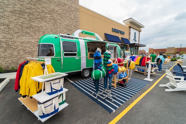 outdoor display featuring a van and bright clothing