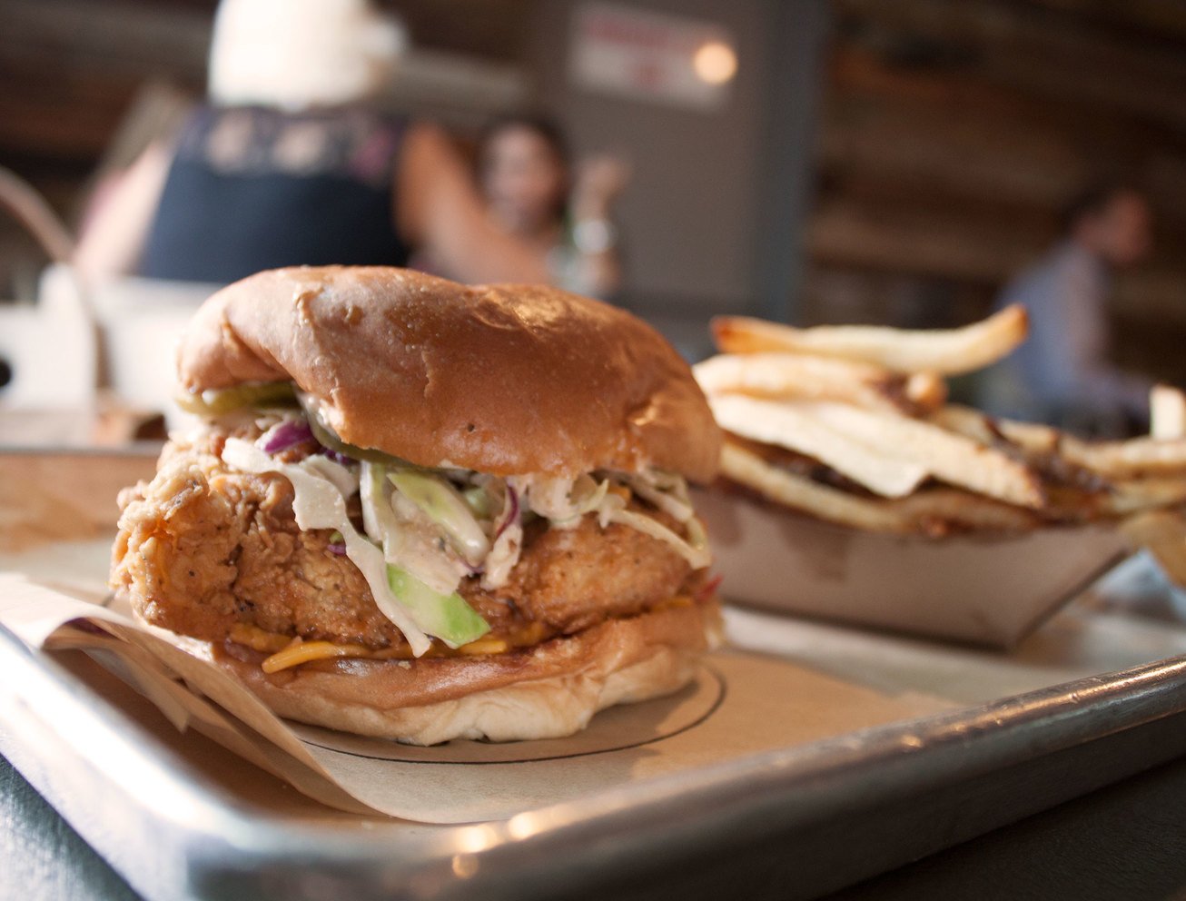 metal tray with fried chicken sandwich and fries