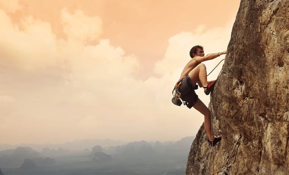 Climber climbing up a mountain. 