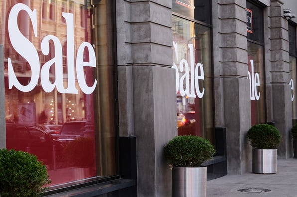 Sale signs on a storefront. 