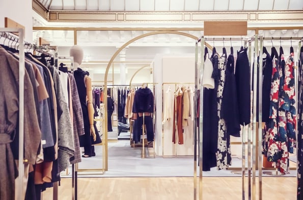 Racks of women's clothes in a store.  