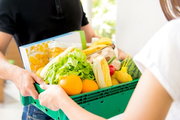 A basket of groceries being delivered to a customer. 
