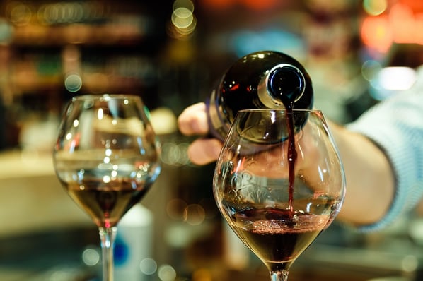 Close-up of wine being poured into a glass. 